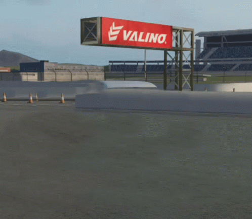 White Van Driving Past Valino Billboard