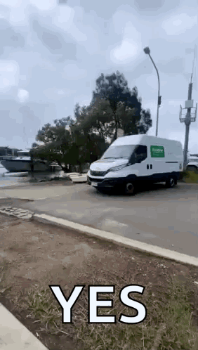 White Van Driving With Yes on Side