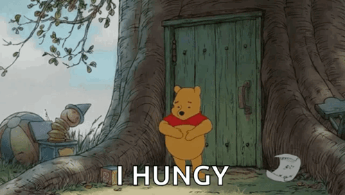 Winnie the Pooh Standing in Front of I Huny Door