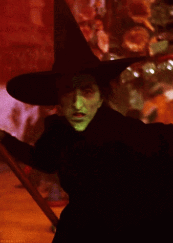 Witch With Green Face Paint And Black Hat GIF
