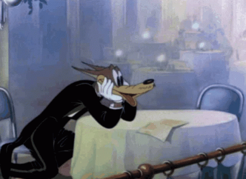 Wolf in Tuxedo Sitting at Table