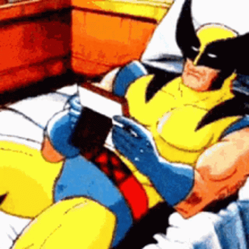 Wolverine Is Reading A Book While Laying On A Bed GIF