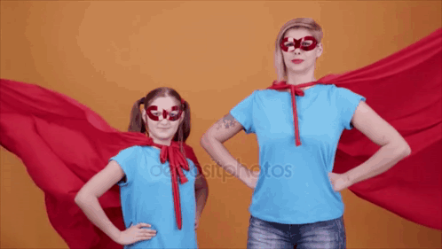 Woman and Little Girl Superhero Costumes Hands on Hips