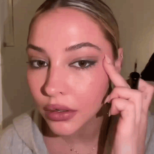 Woman Applying Eyeliner to Eyebrows