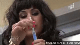 Woman Applying Medication to Nose with Syringe