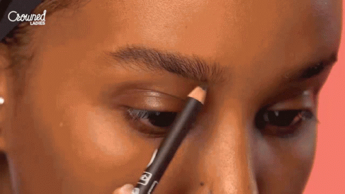 Woman Applying Pencil to Eyebrows With Crowned Ladies Text