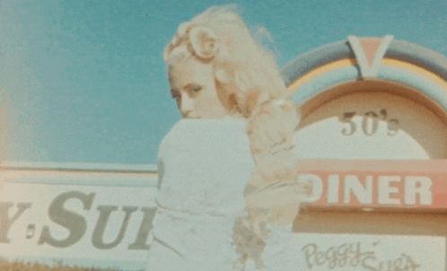 Woman at 50s Diner Sign