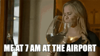 Woman At Airport Drinking In Big Glass GIF