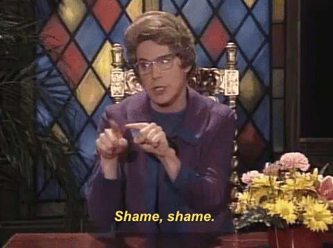 Woman at Desk with Flowers Says Shame Shame