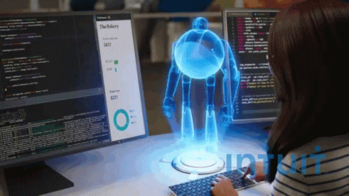 Woman At Desk With Monitor Saying The Bakery GIF