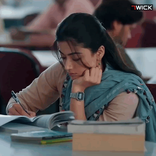 Woman at Desk With Watch Saying Wick