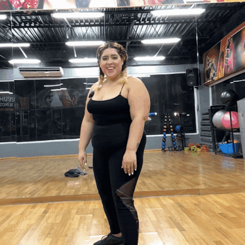 Woman at Gym Mirror With Music Zone Sign