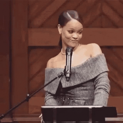 Woman at Microphone Holding Hair in Ponytail