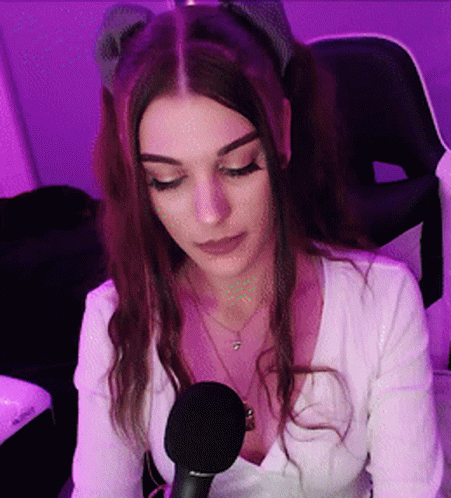 Woman at Microphone in Purple Lights