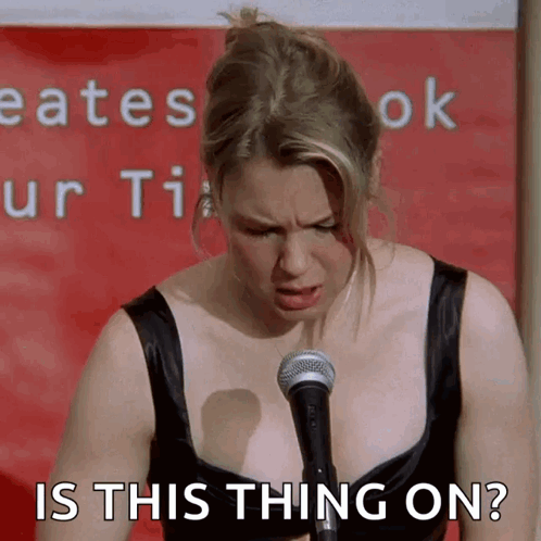 Woman at Microphone Saying Is This Thing On