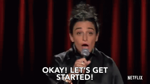 Woman at Microphone Saying Okay Let's Get Started