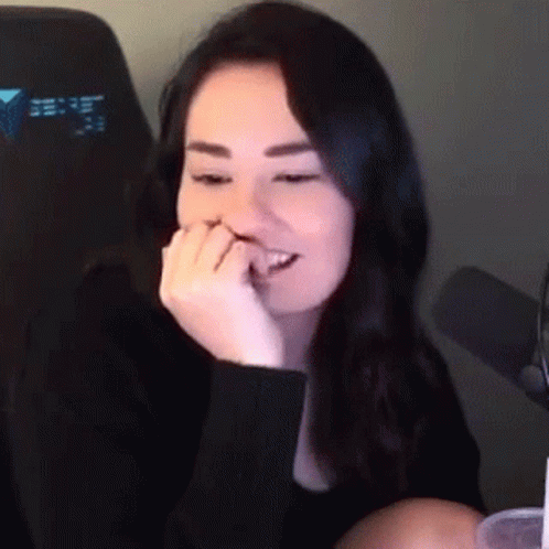 Woman at Microphone With Hand on Mouth