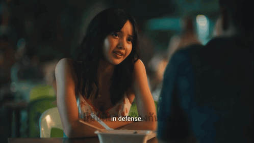 Woman at Table Saying In Defense