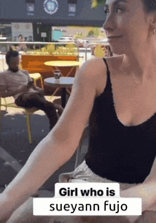 Woman at Table With Caption Girl Who Is Sueyann Fujio
