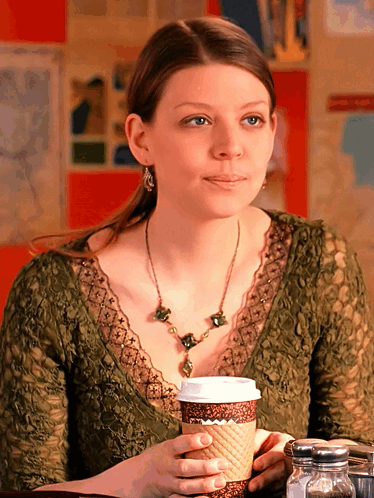 Woman At Table With Cup Of Coffee GIF
