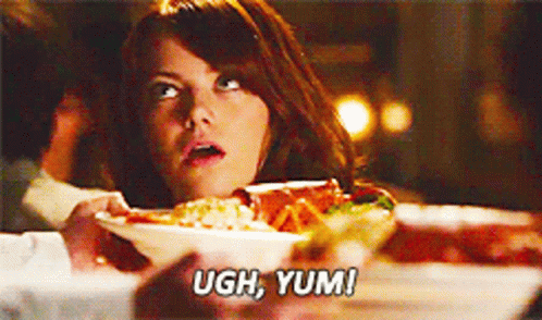 Woman at Table With Plate of Food Saying Ugh Yum