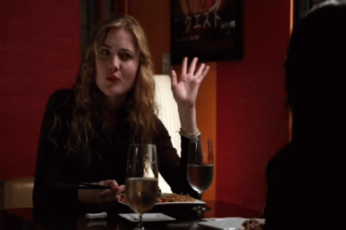 Woman at Table With Wine and Food