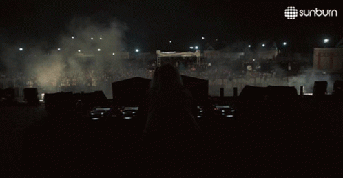 Woman Behind DJ Booth With Sunburn Logo