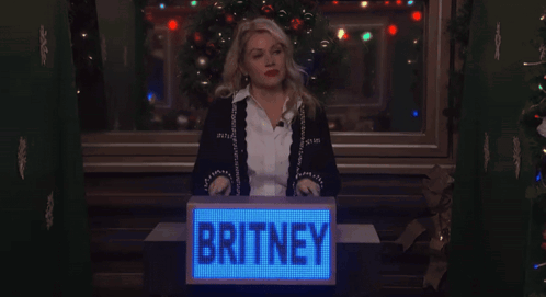 Woman Behind Podium Saying Britney GIF