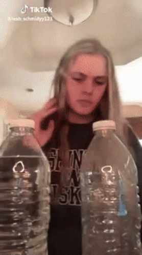 Woman Between Two Water Bottles Talking on Cell Phone