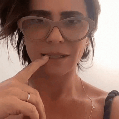 Woman Biting Glasses Nervously GIF