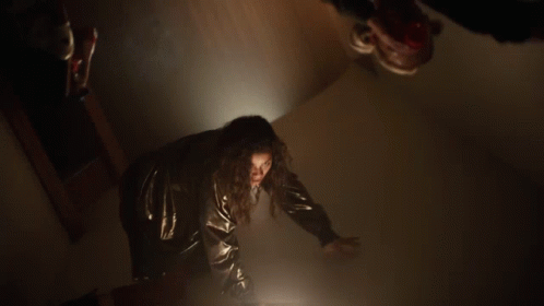 Woman Black Jacket Red Pants Dark Hallway GIF