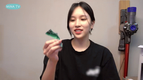 Woman Black Shirt Holding Toy Mina TV Vacuum GIF