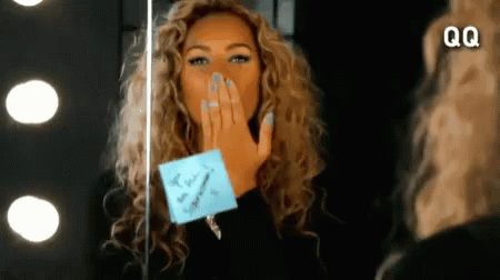 Woman Blowing Kiss In Front Of Mirror With QQ GIF