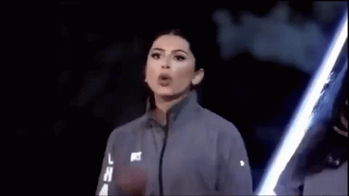 Woman Blowing Kiss With Lightsaber In Dark GIF