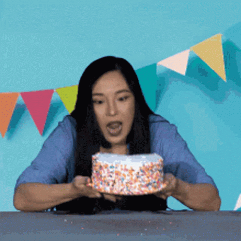 Woman Blowing Out Birthday Candle