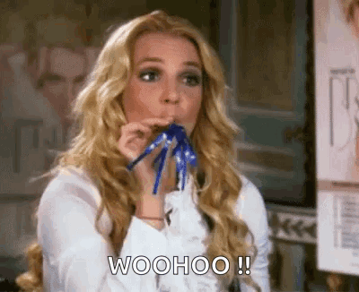 Woman Blowing Party Horn Saying Woohoo