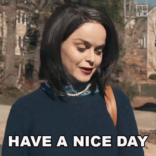 Woman Blue Sweater Pearls Says Have Nice Day