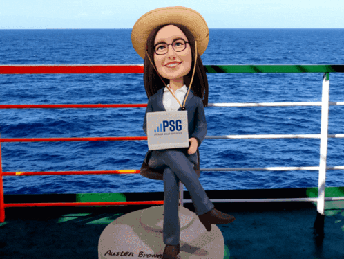 Woman Bobble Head on Rock Holding PSG Sign