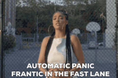 Woman by Chain Link Fence with Automatic Panic Frantic in Fast Lane