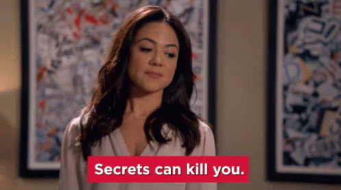 Woman by Painting with 'Secrets Can Kill You' Sign