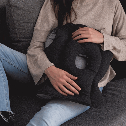 Woman Caressing Throw Pillow On Couch GIF