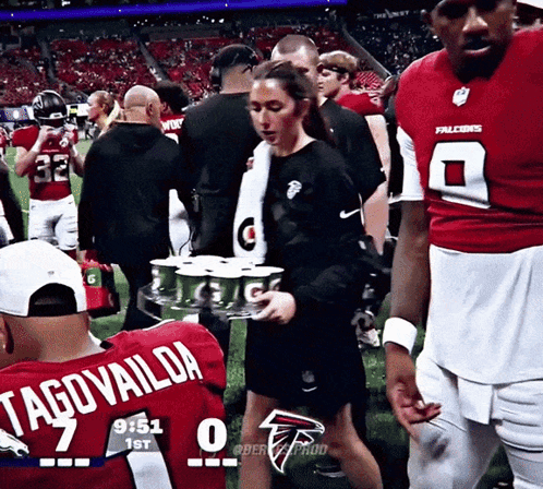 Woman Carrying Tray Of Gatorade In Falcons Jersey Number 7 GIF
