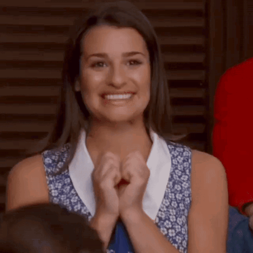 Woman Clapping and Smiling in Crowd