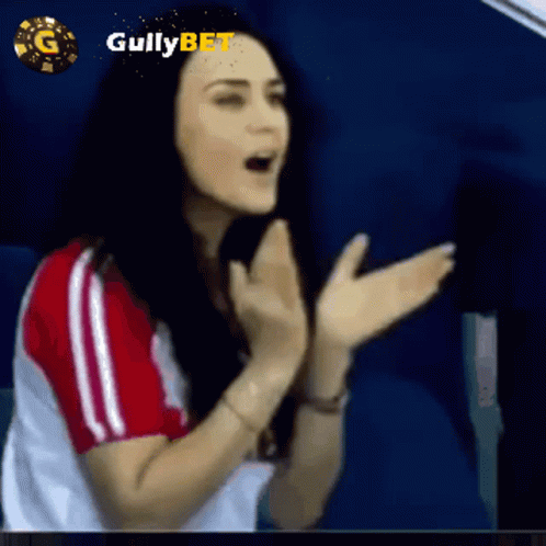Woman Clapping In Front Of Gullybet Logo GIF