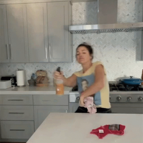 Woman Cleaning Kitchen Counter Wearing Woman-Shirt