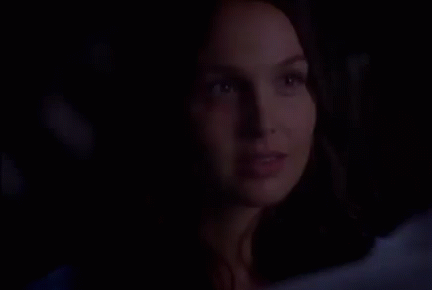 Woman Close Up Smiling In Dark GIF