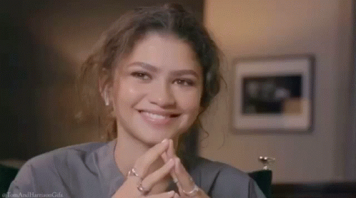 Woman Close Up Smiling With Hands Folded