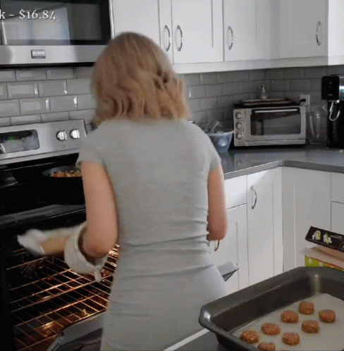 Woman Cooking in Kitchen with $16.84 Tag