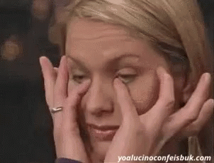 Woman Covering Eyes Looking At Camera GIF