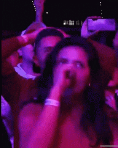 Woman Covering Eyes While Man Photographs